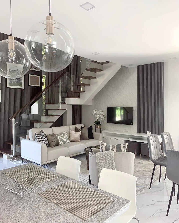 Modern living room with glass staircase