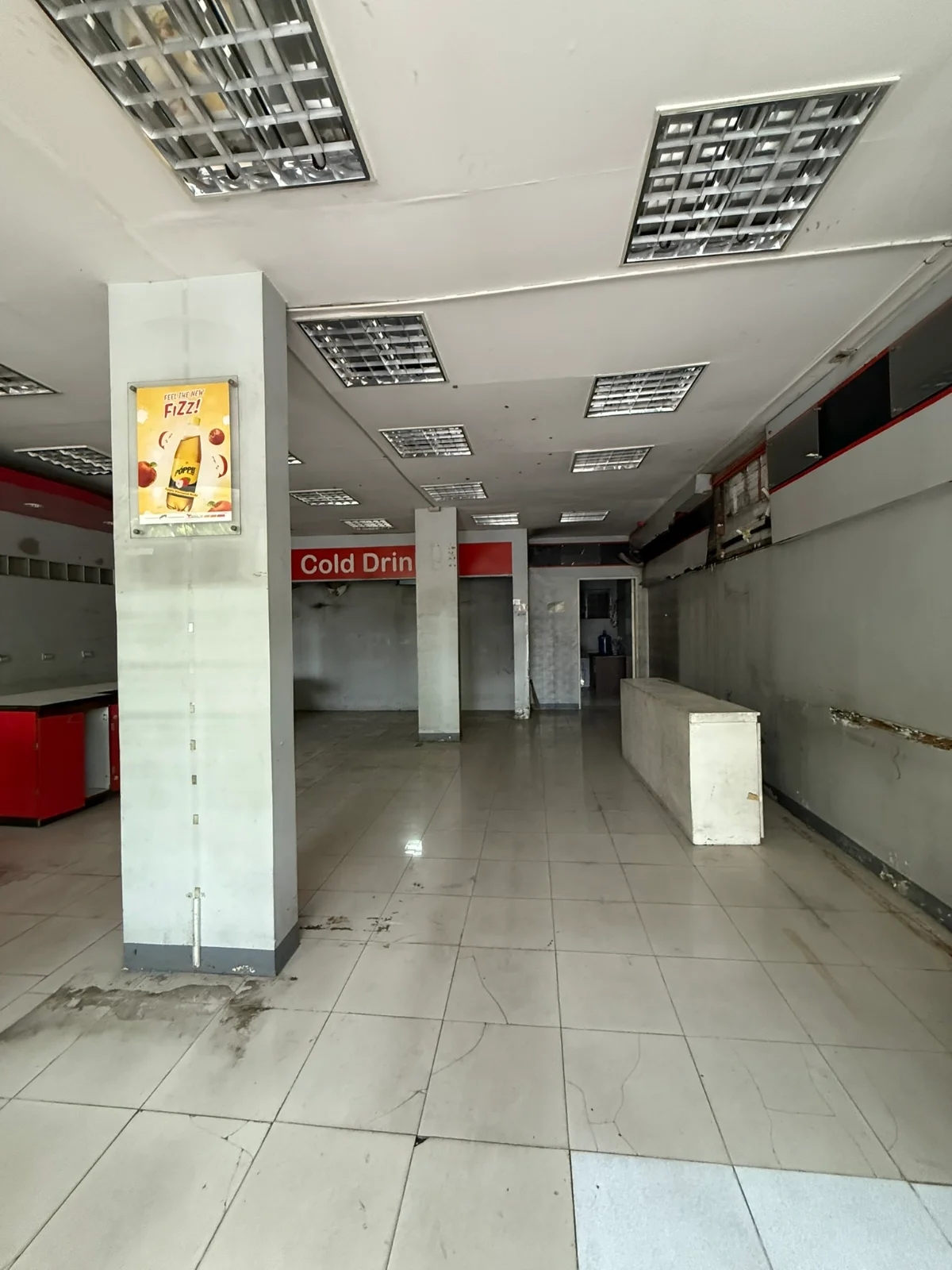 The unit before work began: a stripped-out retail space