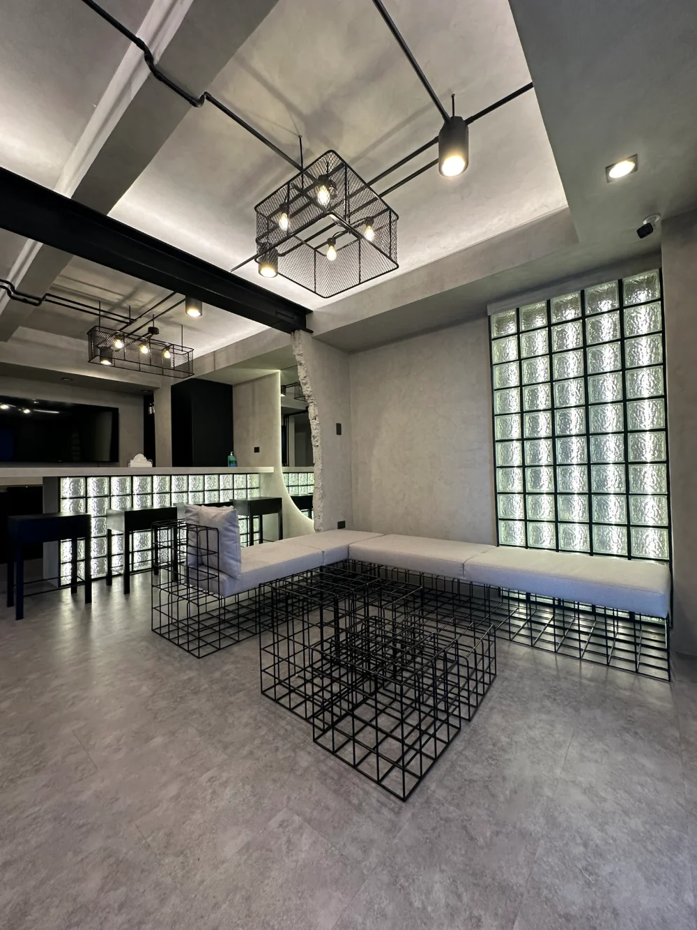 Clinic lounge with banquette seating and glass-block wall