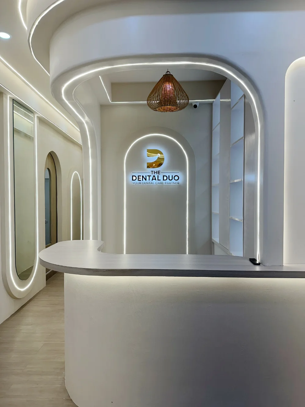 Reception desk with backlit clinic signage