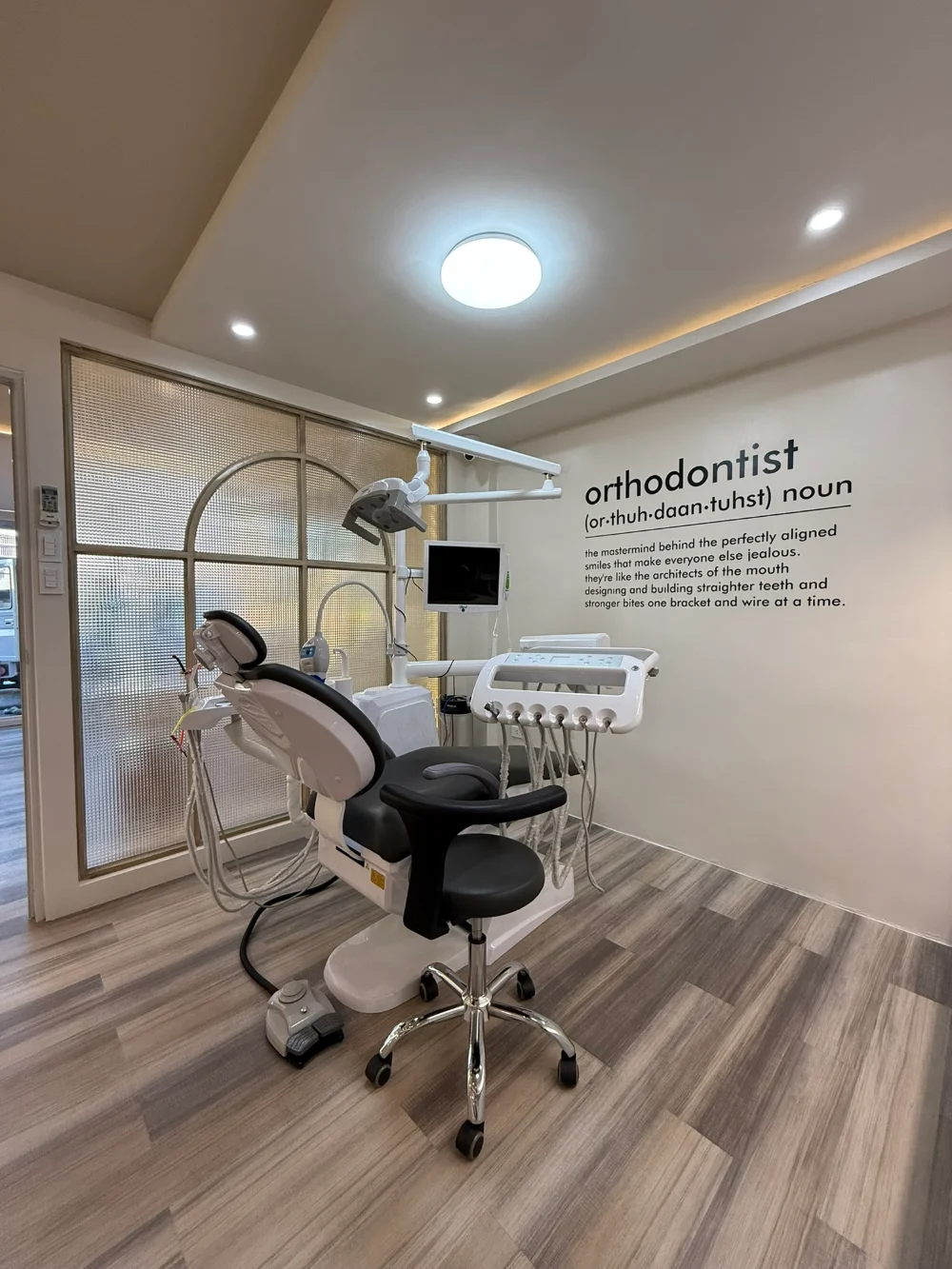 Dental treatment room with chair and overhead light
